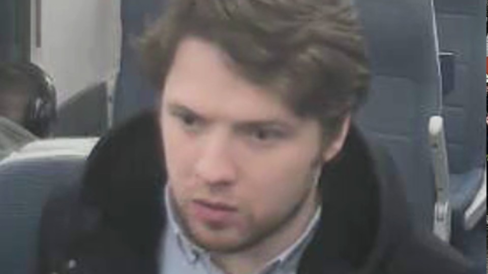 Surveillance image of a man on public transport.