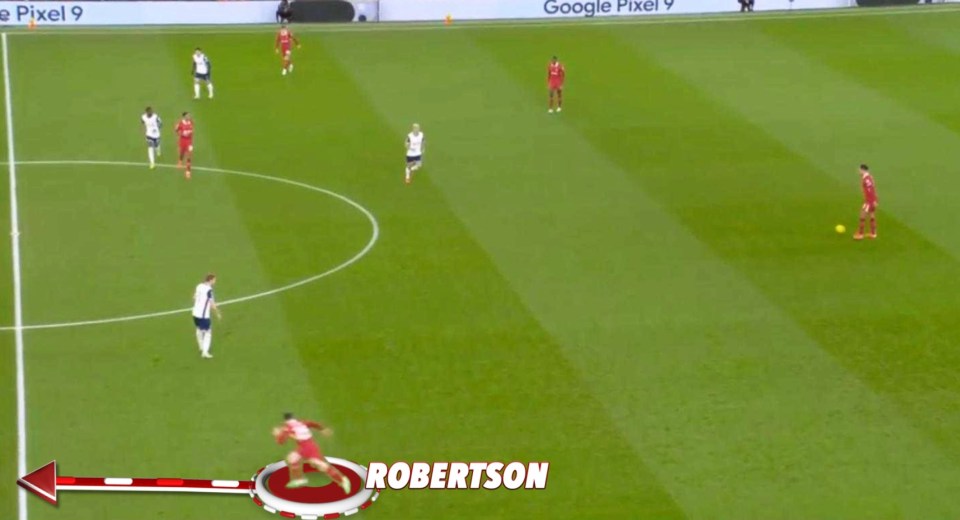 Robertson sliding tackle on a soccer field.