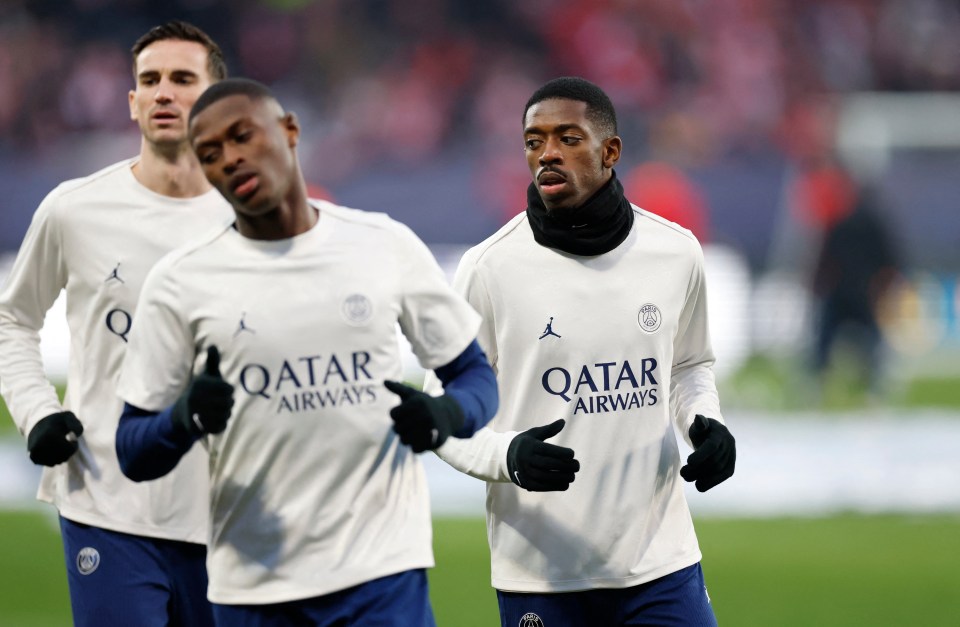 Soccer Football - Champions League - Knockout Phase Playoff - First Leg - Brest v Paris St Germain - Stade de Roudourou, Guingamp, France - February 11, 2025 Paris St Germain's Nuno Mendes, Paris St Germain's Ousmane Dembele and Paris St Germain's Fabian Ruiz during the warm up before the match REUTERS/Stephane Mahe