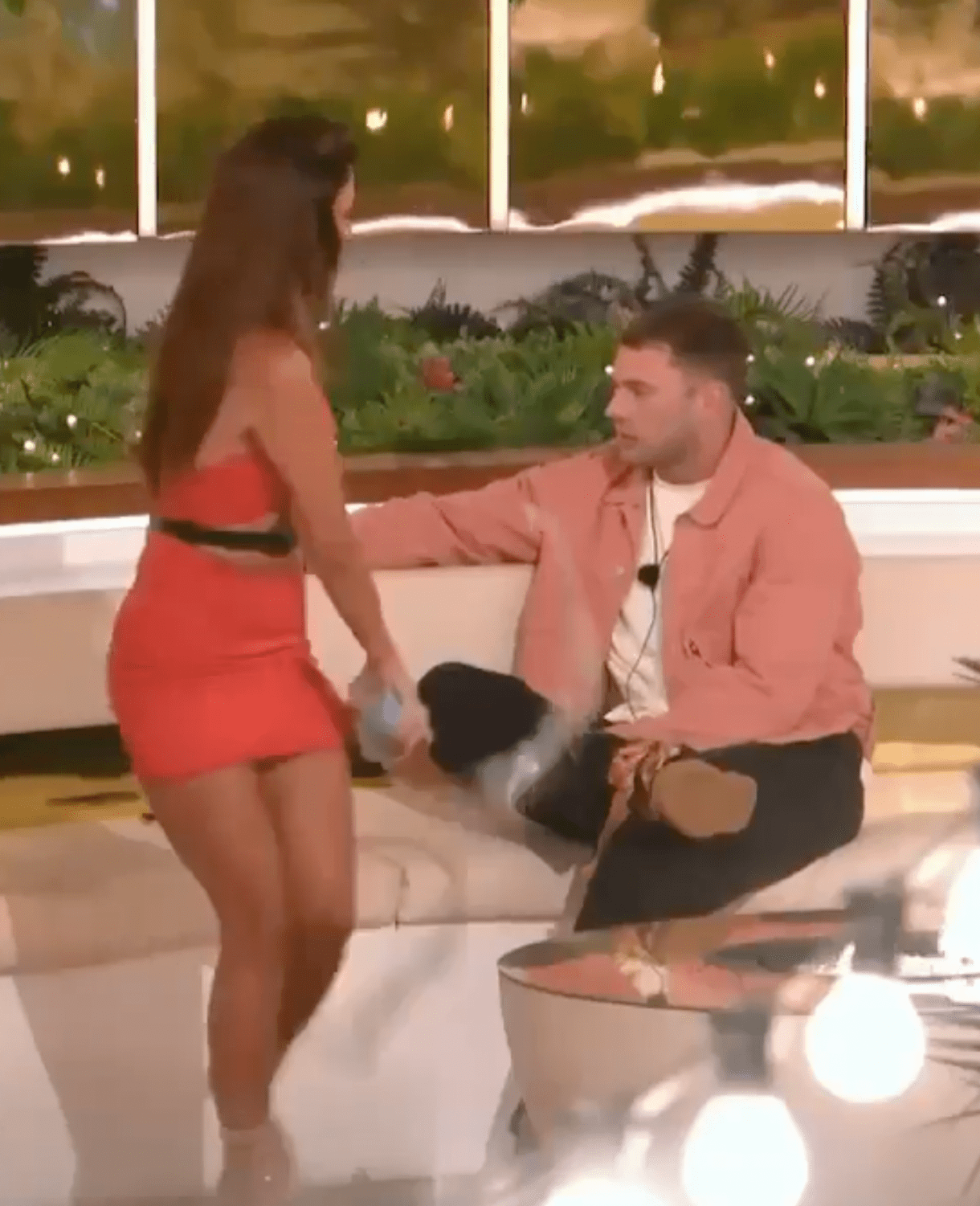 Screenshot of a man and woman interacting on a reality TV show.