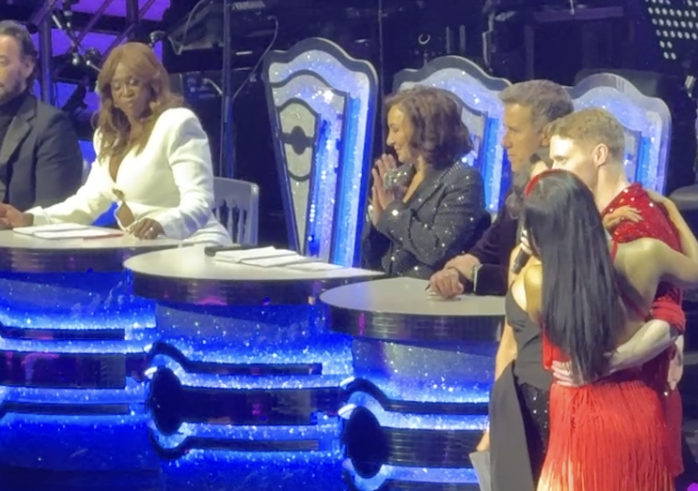 Screenshot of judges and contestants at a dance competition.