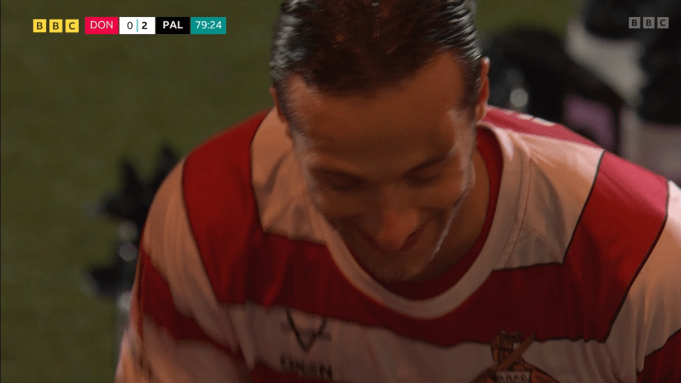 Close-up of a sweating rugby player smiling.