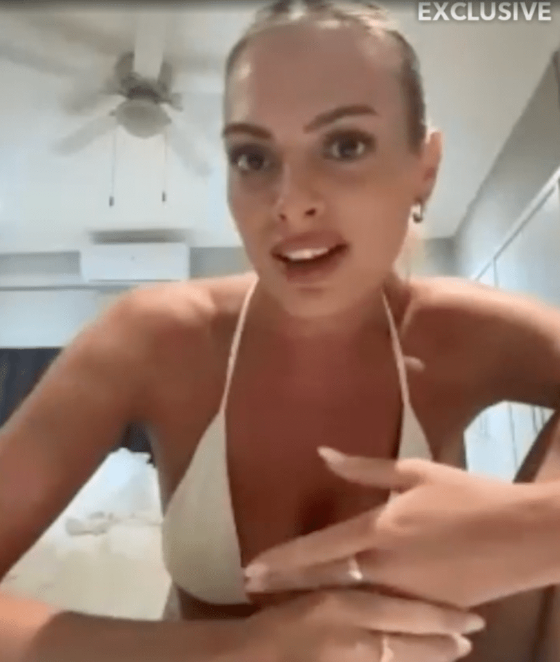 Screenshot of a woman in a white bikini top speaking to the camera.