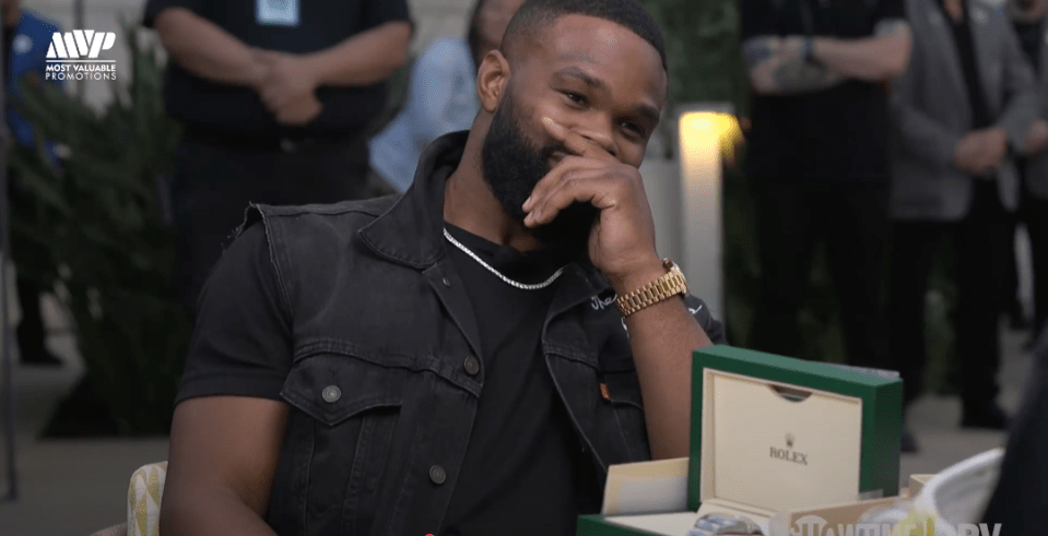 Man smiling while looking at a Rolex watch box.