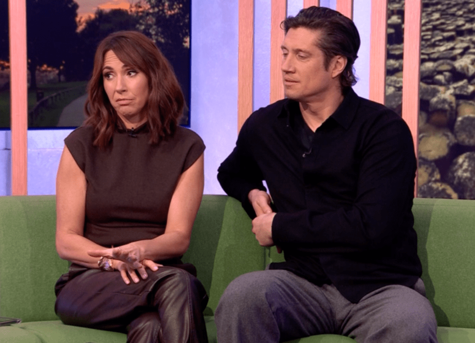 Screenshot of a man and woman sitting on a green couch.