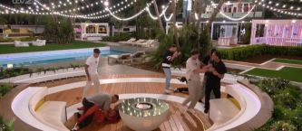 Screenshot of a fight breaking out amongst several people in a villa at night.