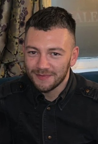 Portrait of a man in a dark shirt.