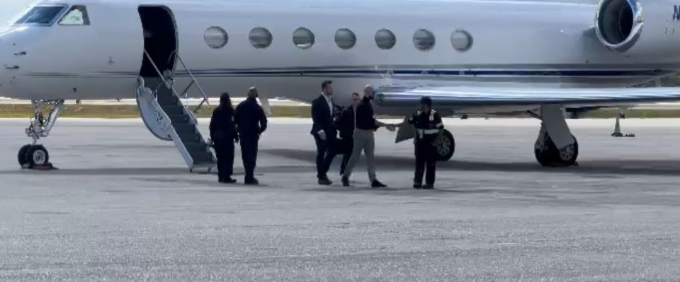 People disembarking from a private jet.