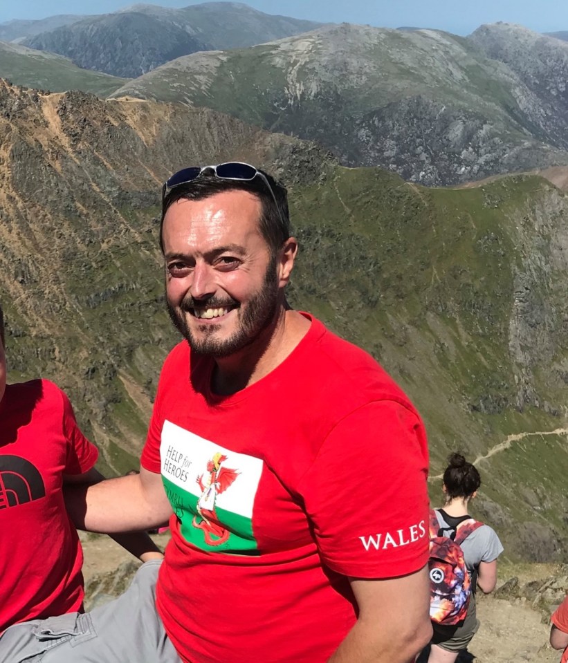 Man in red Help for Heroes Wales t-shirt on mountain.