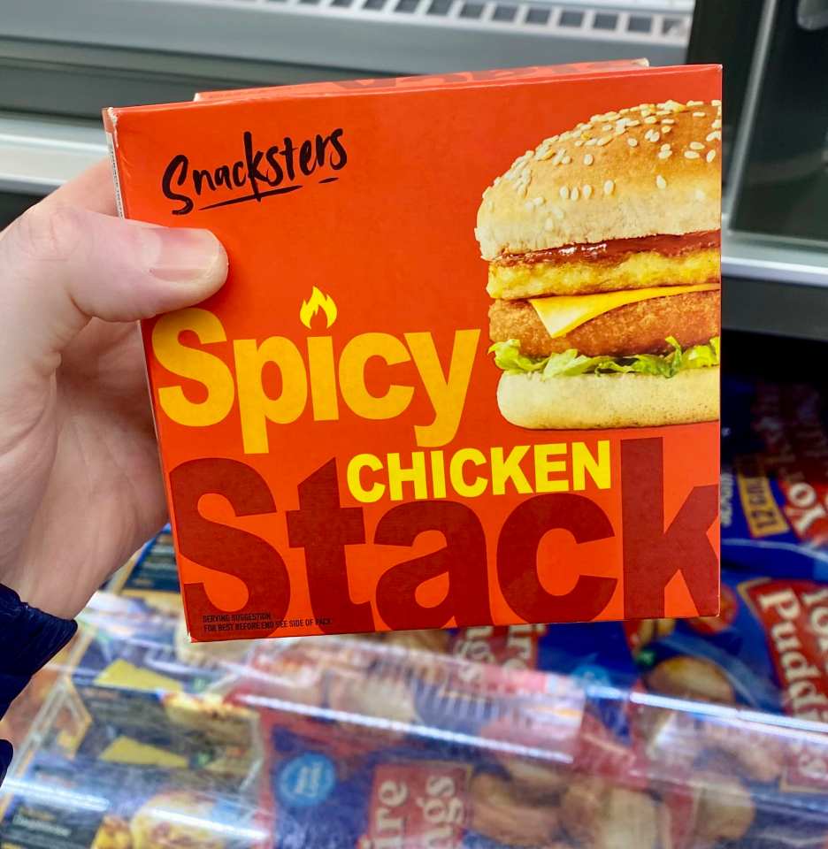 Hand holding a box of Snacksters Spicy Chicken Stack.