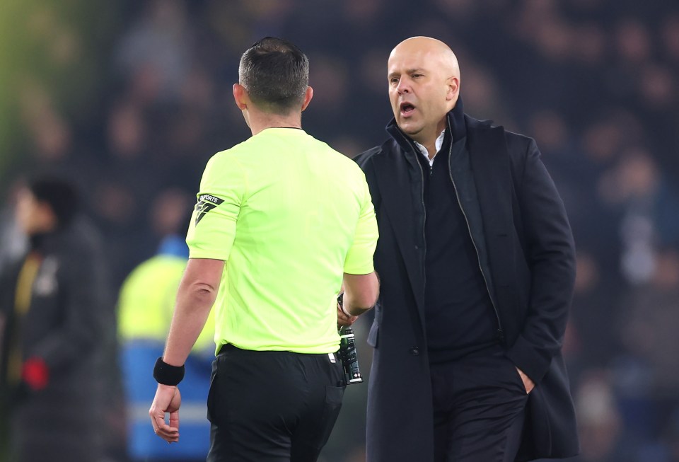 Arne Slot, Liverpool manager, speaking with a referee.