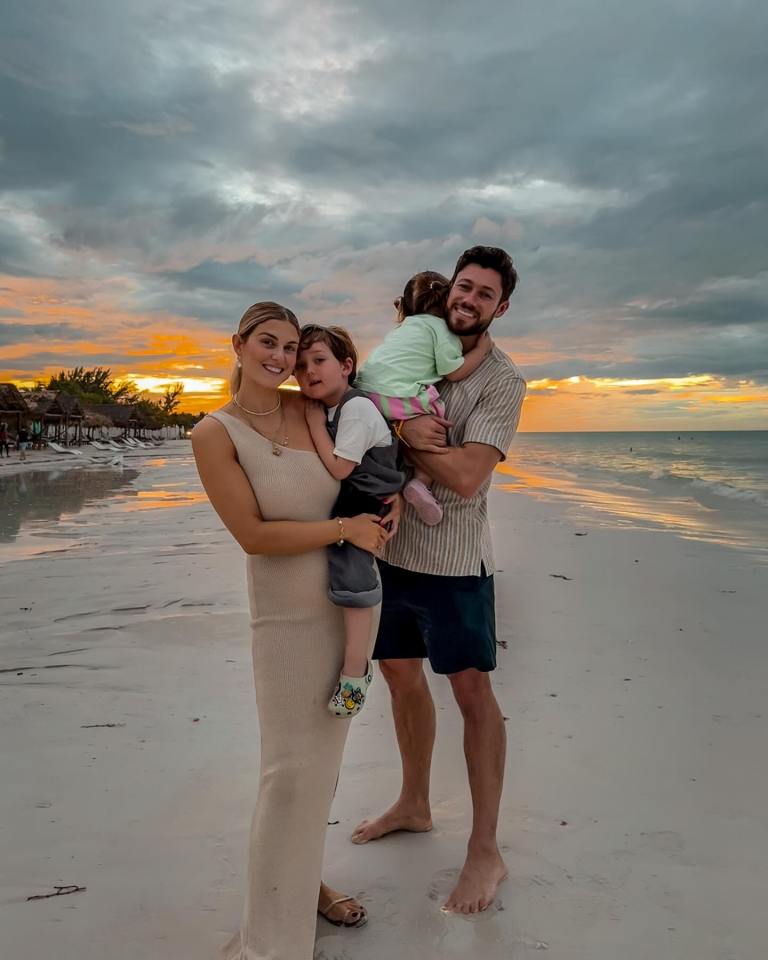 Family on a beach at sunset.