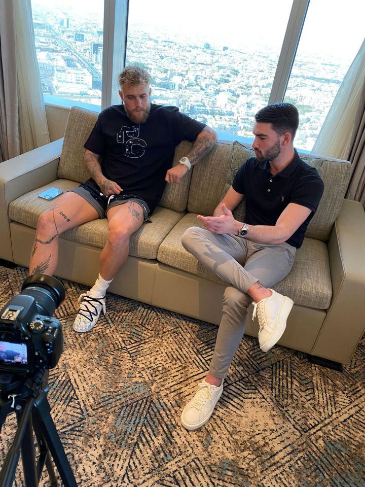 Two men sitting on a couch during a video interview.