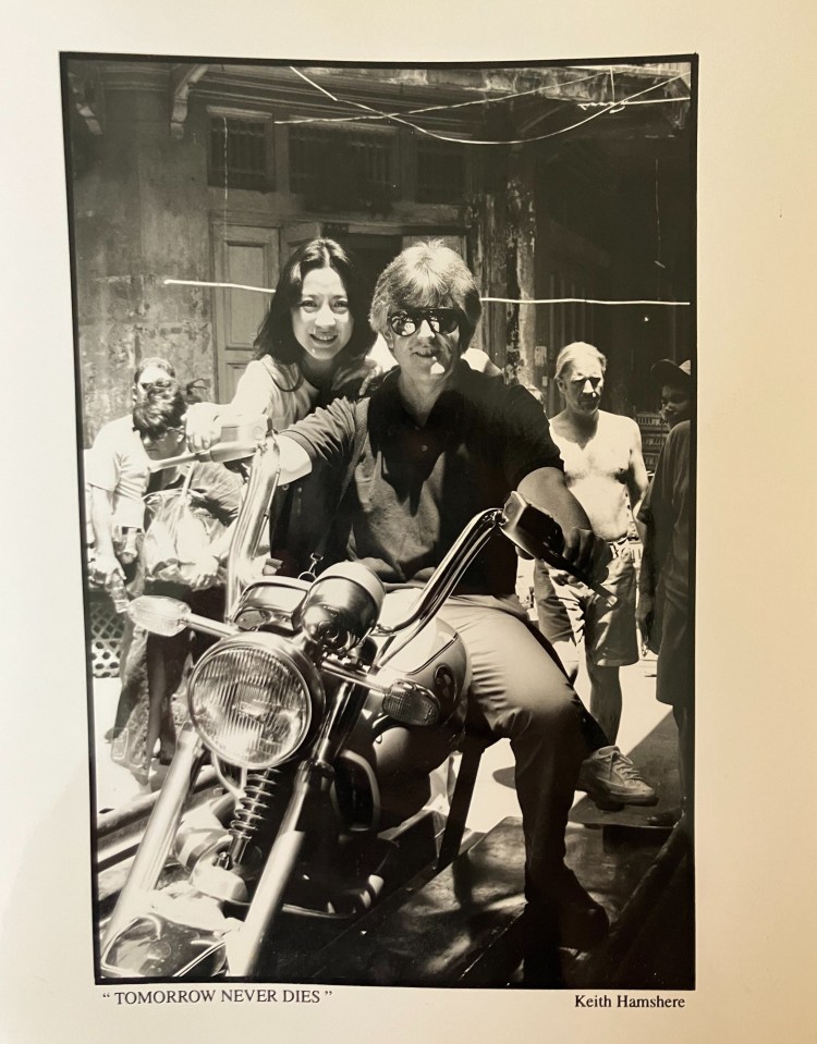 Black and white photo of Garth Pearce on a motorcycle with two other people.