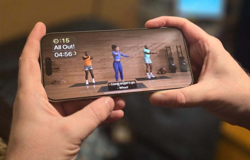 Smartphone displaying fitness workout video.