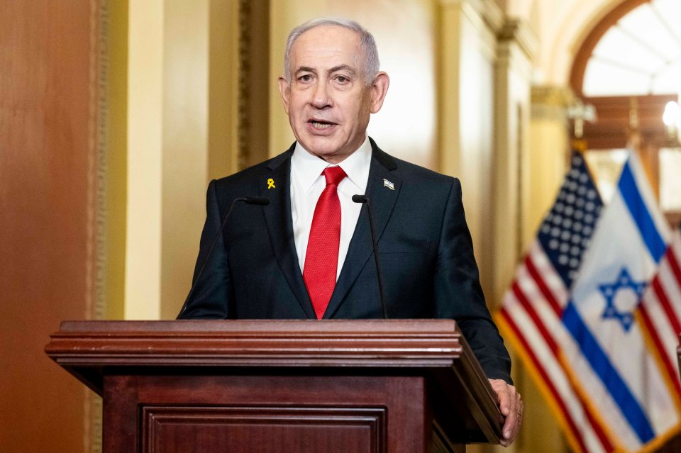 Benjamin Netanyahu speaking at a podium.