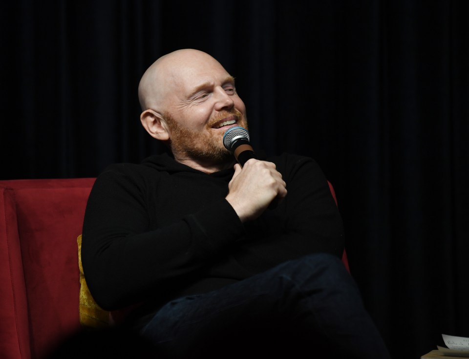 Bill Burr speaking into a microphone.