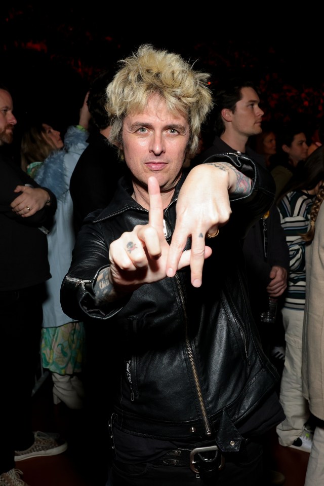 Billie Joe Armstrong of Green Day at a benefit concert, making the "LA" hand sign.