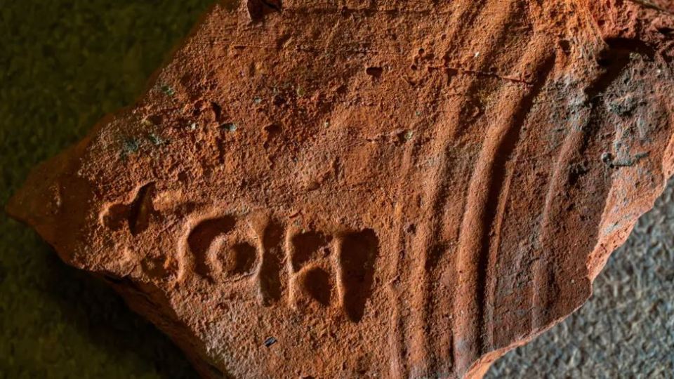 Close-up of a 2000-year-old brick with markings.