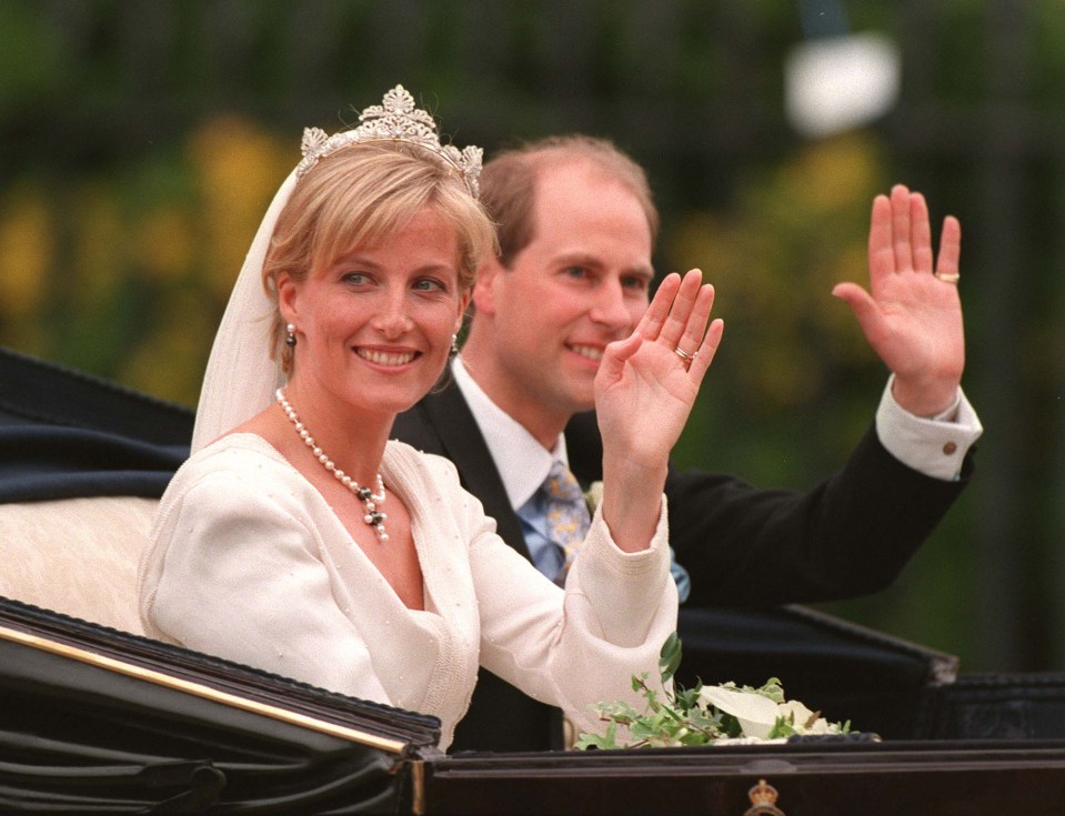 Prince Edward and Sophie Rhys-Jones waving from a carriage after their wedding.