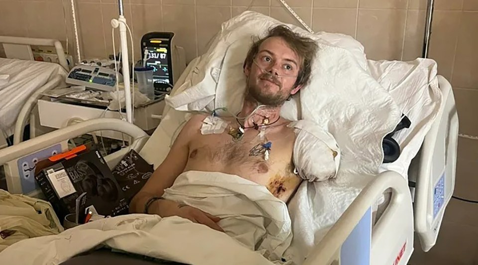 British humanitarian worker Edward Scott in a hospital bed, having lost an arm and leg.