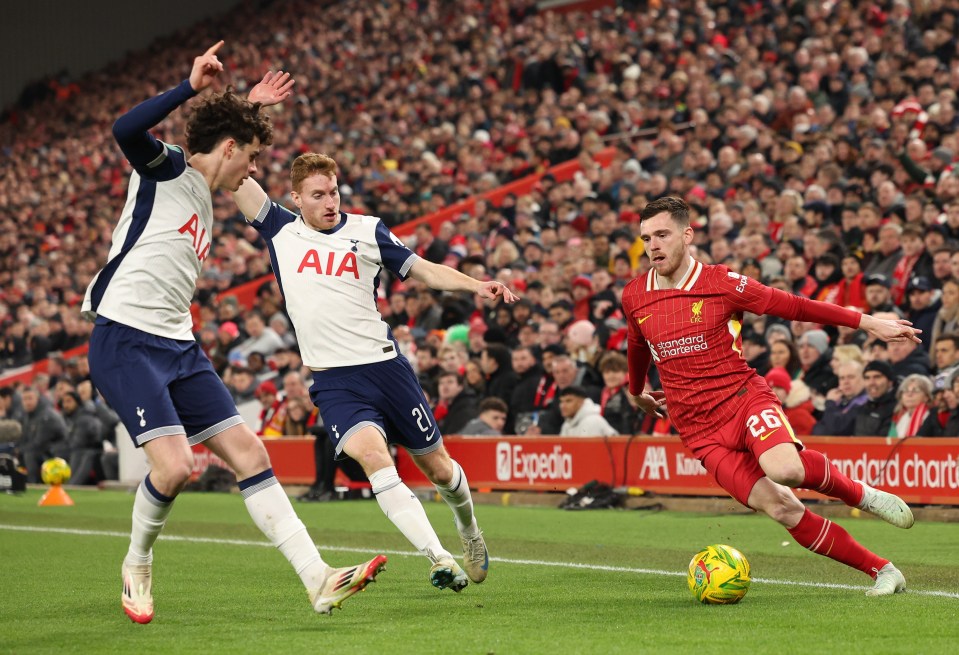 Liverpool's Andrew Robertson tackles Tottenham's Dejan Kulusevski during a Carabao Cup match.