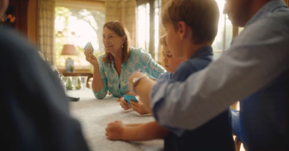 Grandparents and grandchildren playing cards.