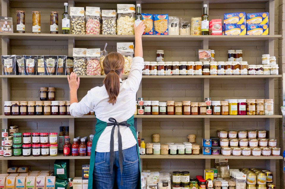 Woman stocking shelves in a grocery store.