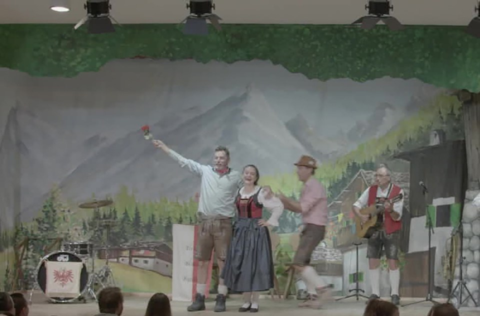 Screengrab of a musical performance in traditional Bavarian costumes.