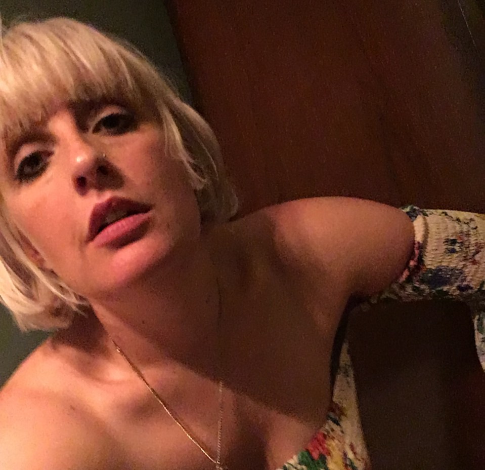 Self-portrait of a woman with blonde bangs and a floral top.