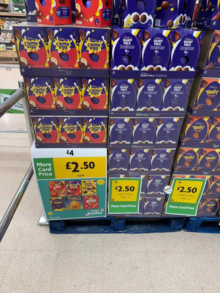 Supermarket display of Cadbury Creme Eggs, Dairy Milk Buttons, and Twirl Easter candy, priced at £2.50 each.