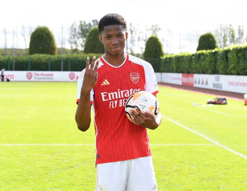 Chido Obi-Martin holding a soccer ball and making a three-finger gesture after scoring a hat trick for Arsenal.