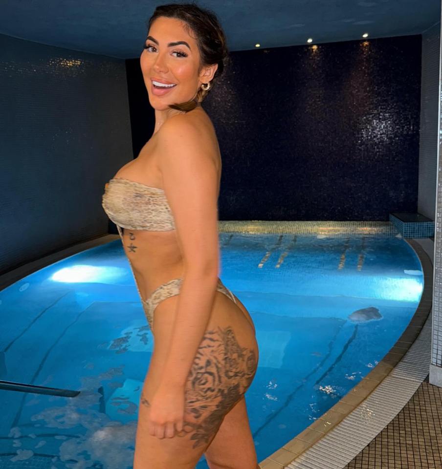 Chloe Ferry in a bikini by a pool.