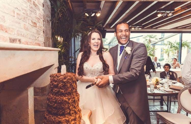 Bride and groom cutting a wedding cake.