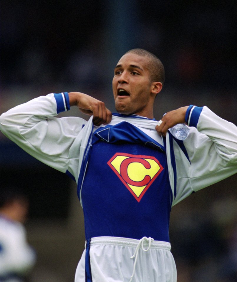 Clarke Carlisle of Queens Park Rangers revealing a Superman-themed undershirt.