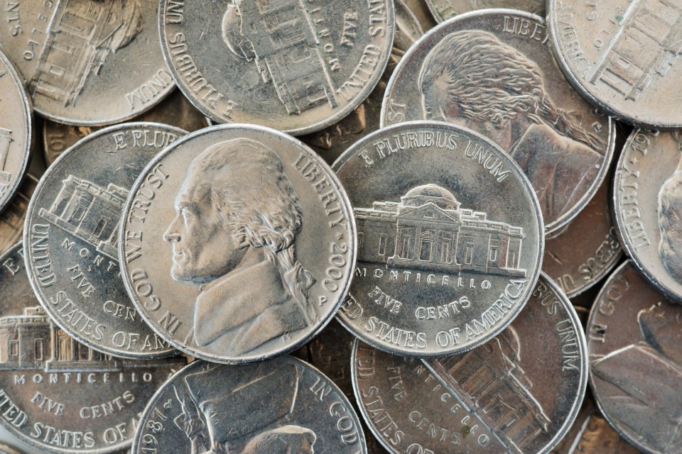 Close-up of a pile of US nickels.