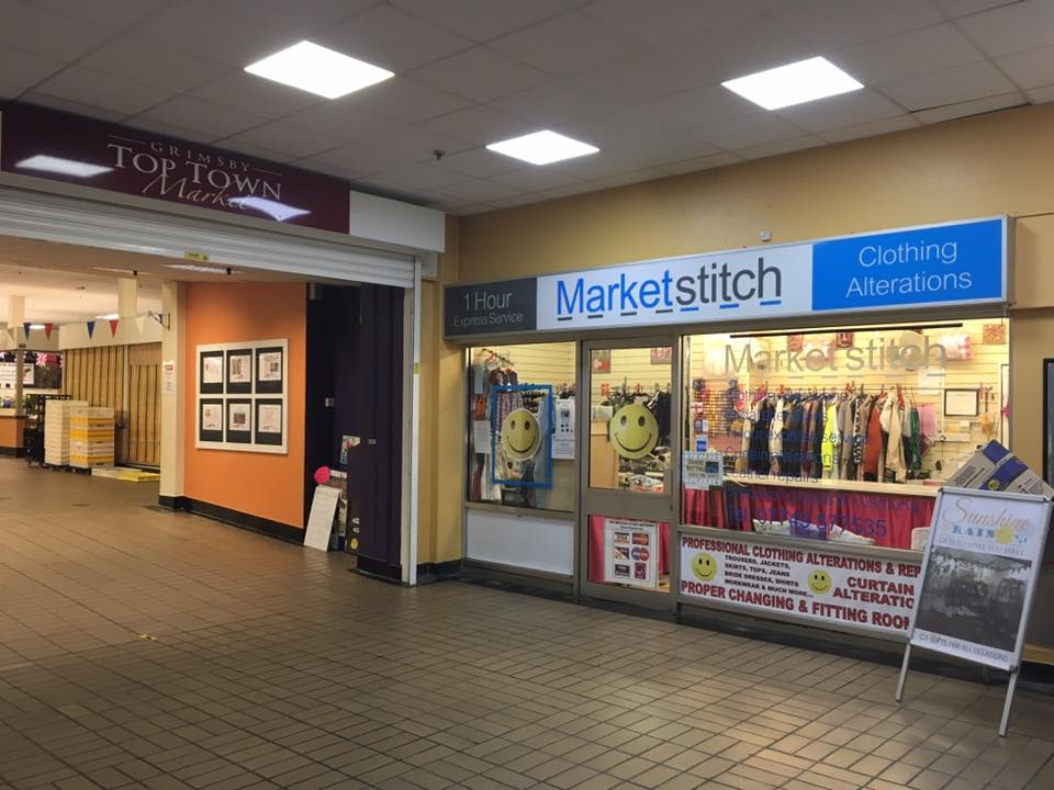 Interior view of Grimsby Top Town Market, showing Market Stitch clothing alterations shop.