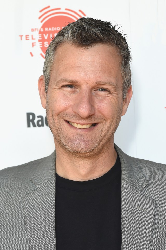 Headshot of Adam Hills.