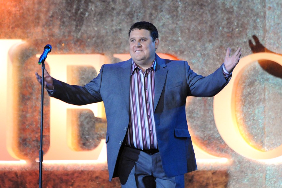 Peter Kay performing live on stage.