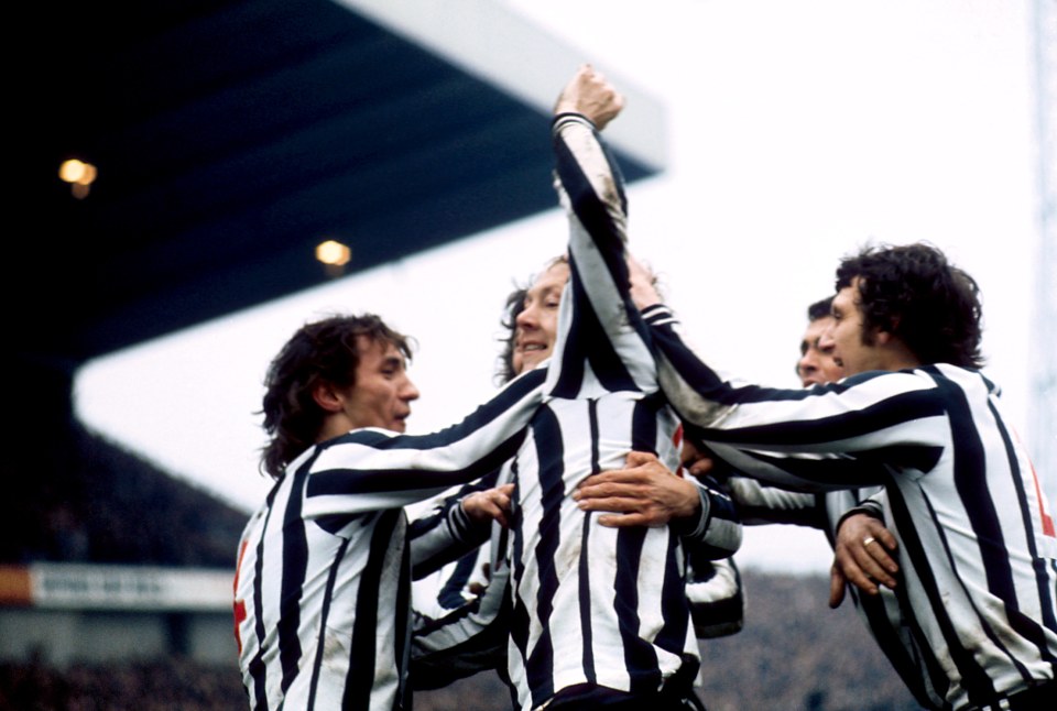 Newcastle United teammates celebrating a goal.