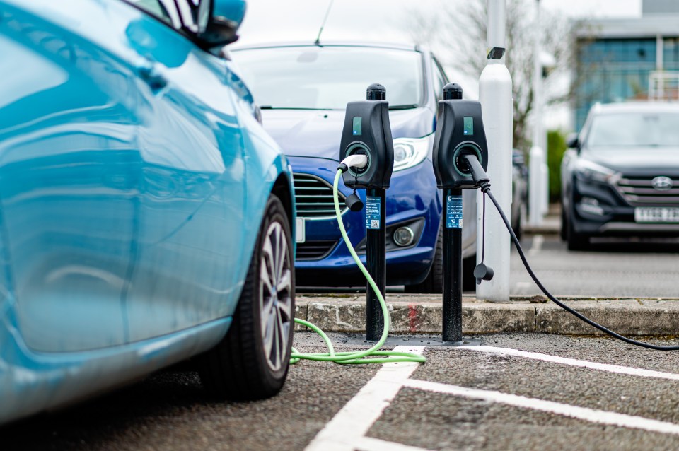 Electric vehicle charging station with cars plugged in.