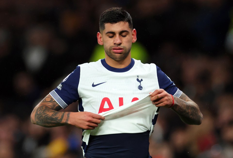 Cristian Romero of Tottenham Hotspur reacts to an injury during a soccer match.