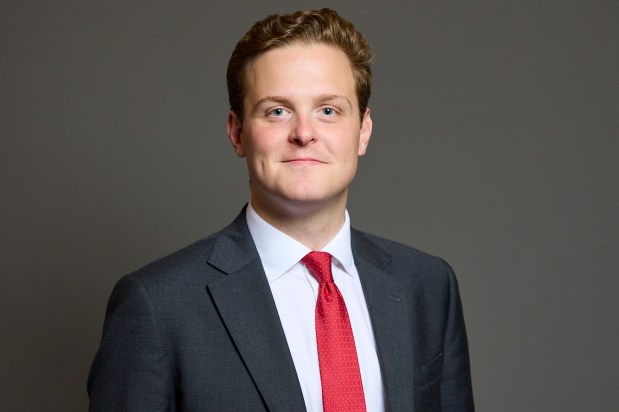 Portrait of Oliver Ryan, Burnley MP, wearing a dark suit and red tie.