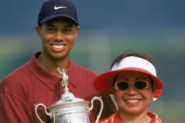 Tiger Woods holding the US Open trophy with his mother.