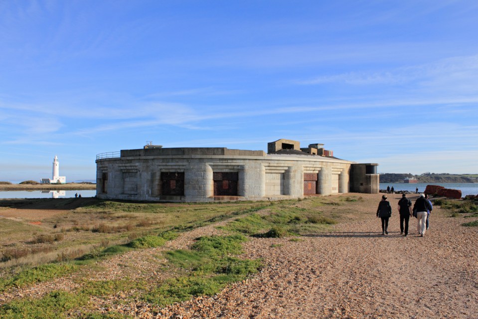 Hurst Castle in Hampshire, England, with a lighthouse in the background.