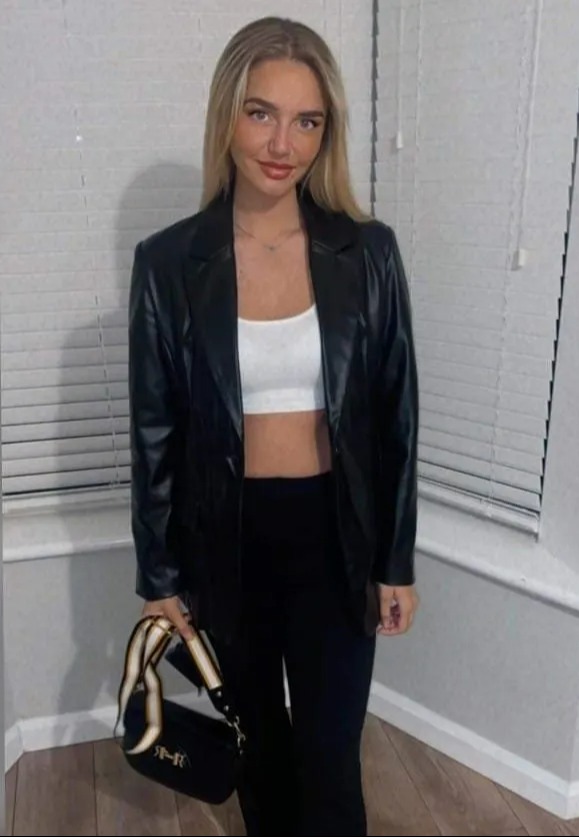 Woman in black leather jacket and black pants.