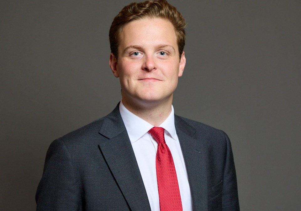 Portrait of Oliver Ryan, Burnley MP, wearing a dark suit and red tie.