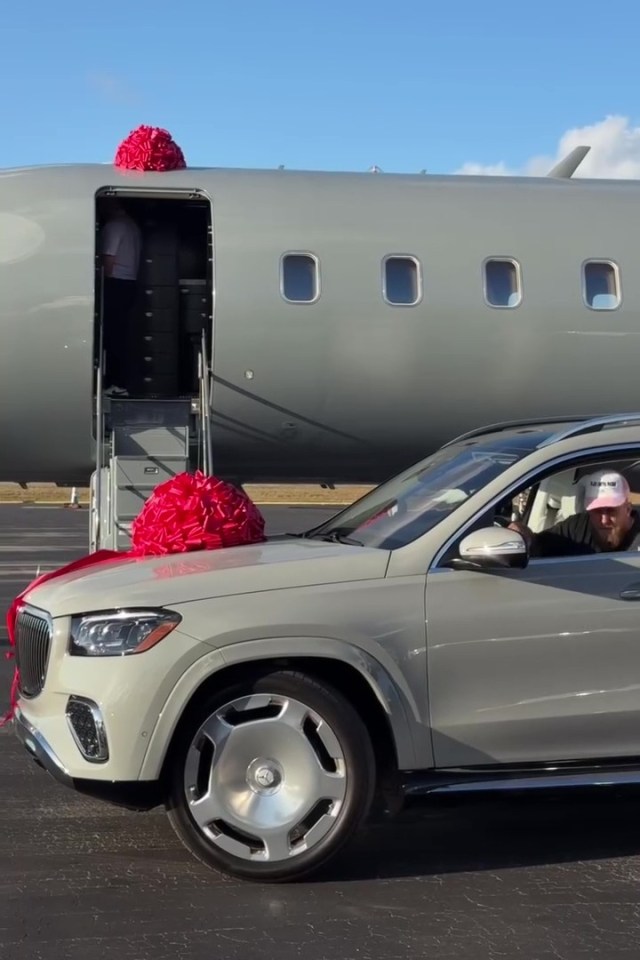 Man in SUV in front of private jet.