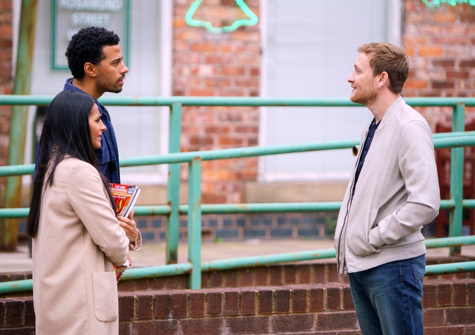 Three people talking outdoors.