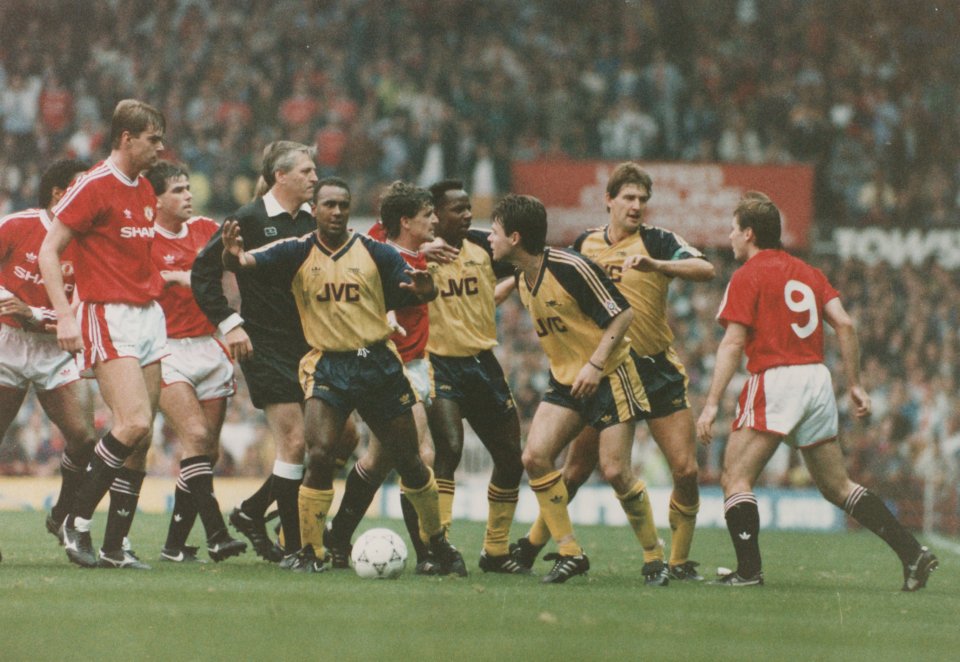 David Rocastle of Arsenal separating Arsenal and Manchester United players after a fight.